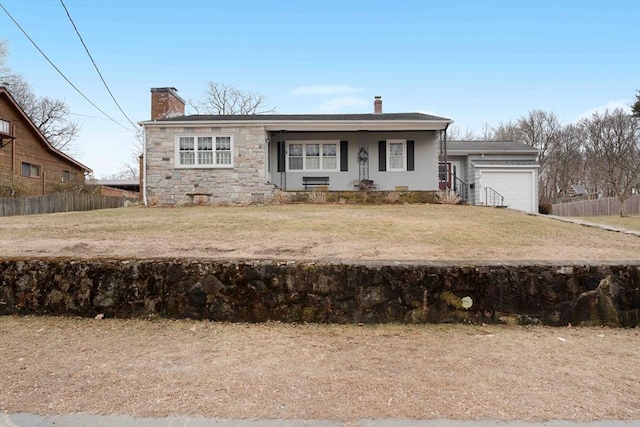 view of front of home featuring a garage, fence, a chimney, and a front lawn