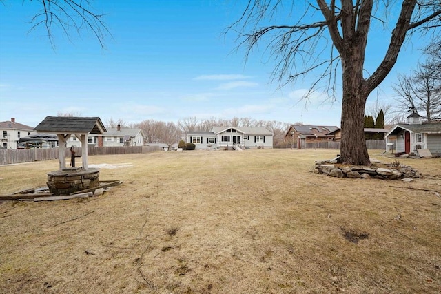 view of yard with a residential view and fence