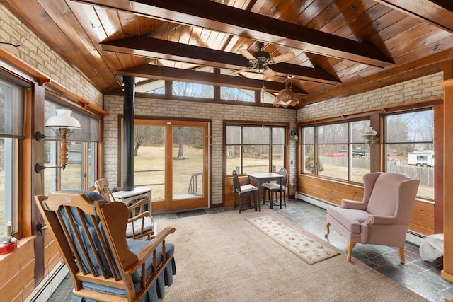 sunroom / solarium with a baseboard radiator, a wood stove, wooden ceiling, and lofted ceiling with beams