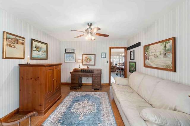 living area with baseboards, ceiling fan, and wallpapered walls