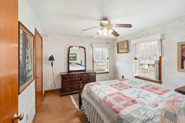 bedroom with ceiling fan, carpet, and wallpapered walls