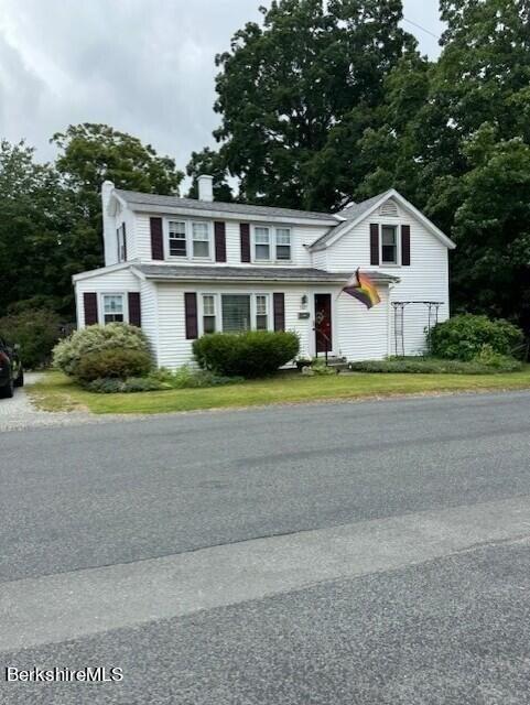 back of property featuring a yard and a deck