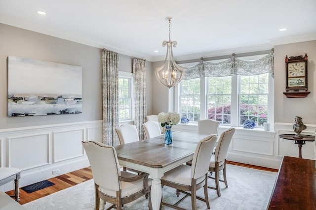 11 Teal Cir, Mashpee, MA 02649 - dining room featuring light wood finished floors, a chandelier, a decorative wall, wainscoting, and crown molding