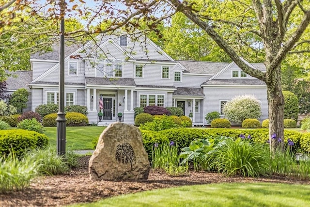 11 Teal Cir, Mashpee, MA 02649 - shingle-style home with a front yard and roof with shingles