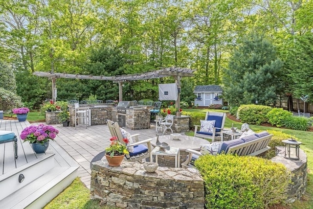 11 Teal Cir, Mashpee, MA 02649 - deck with an outdoor kitchen, an outbuilding, and view of wooded area