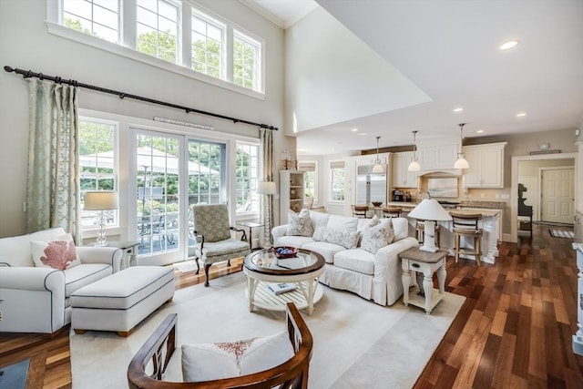 11 Teal Cir, Mashpee, MA 02649 - living area with dark wood-type flooring, recessed lighting, crown molding, and a high ceiling