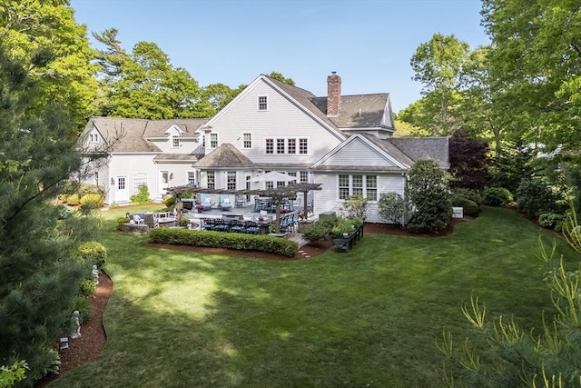 11 Teal Cir, Mashpee, MA 02649 - rear view of property featuring a chimney and a lawn