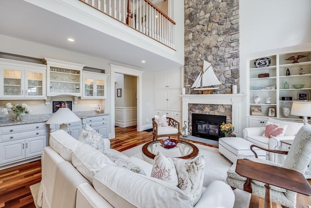 11 Teal Cir, Mashpee, MA 02649 - living room featuring wood finished floors, a fireplace, and a towering ceiling
