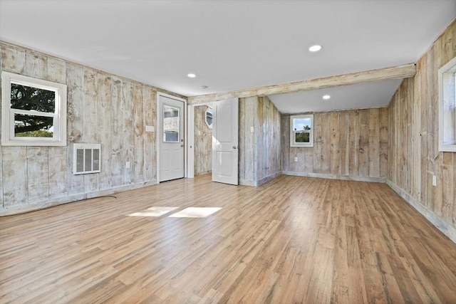 unfurnished room with baseboards, visible vents, wood finished floors, beam ceiling, and recessed lighting