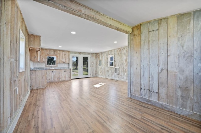 unfurnished living room featuring visible vents, french doors, light wood-style flooring, and recessed lighting