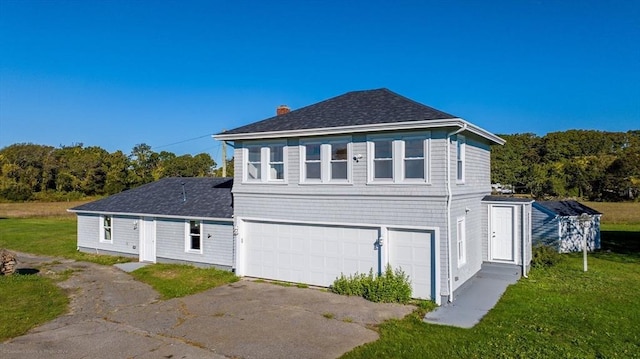 view of property exterior with a yard, a chimney, an attached garage, and roof with shingles