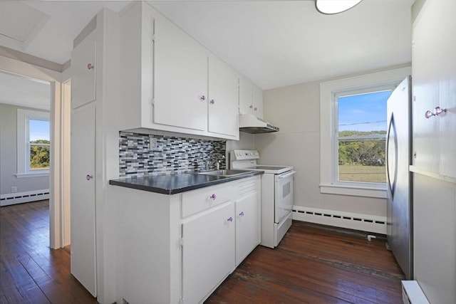 kitchen with under cabinet range hood, a baseboard heating unit, white electric range, freestanding refrigerator, and decorative backsplash