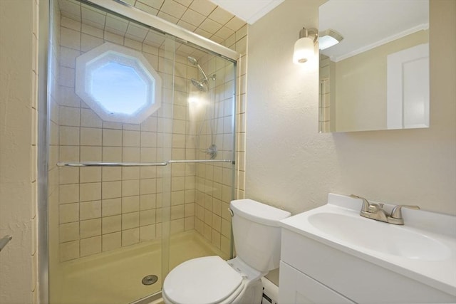 bathroom featuring toilet, a shower stall, crown molding, and vanity