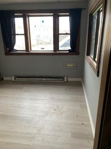 spare room with light hardwood / wood-style floors and a baseboard radiator