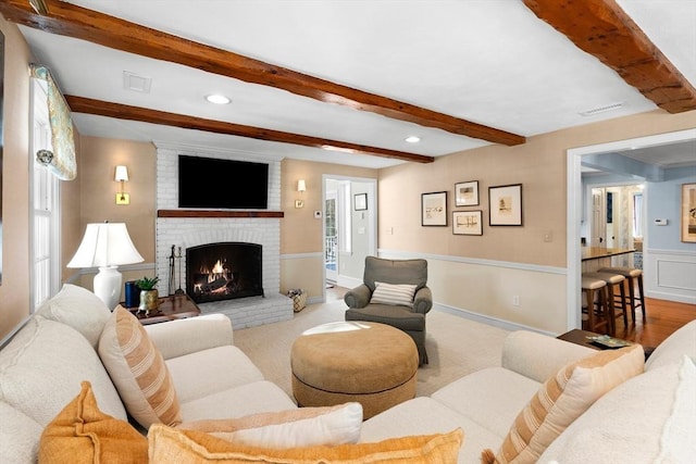 living room with beamed ceiling and a fireplace