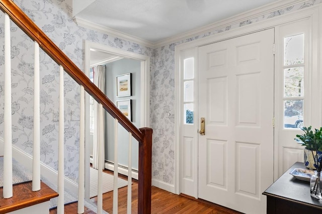 foyer entrance with crown molding and hardwood / wood-style floors