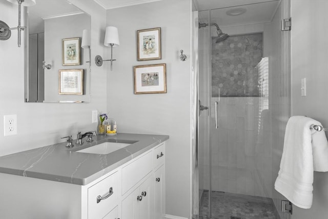 bathroom featuring vanity, crown molding, and walk in shower