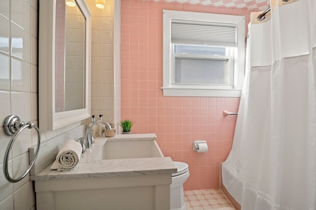 bathroom with tile patterned flooring, toilet, vanity, tile walls, and a shower with shower curtain