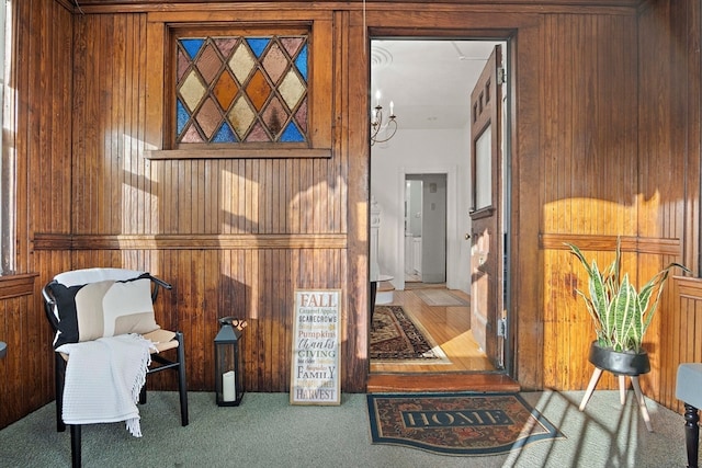 living area with wood walls and carpet floors