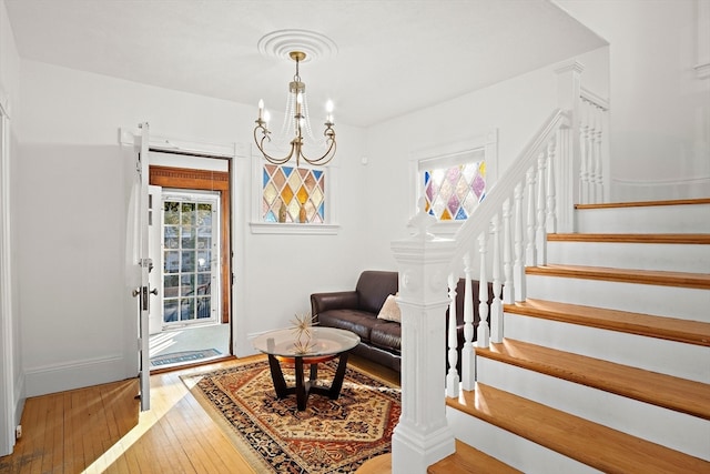 entryway featuring wood-type flooring and a notable chandelier