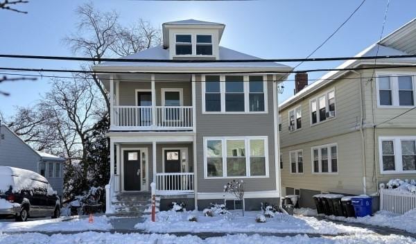 view of front of property with a balcony and a porch