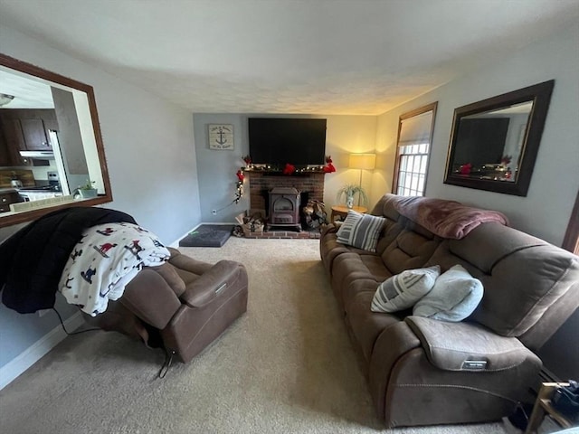 living room featuring carpet floors and a wood stove