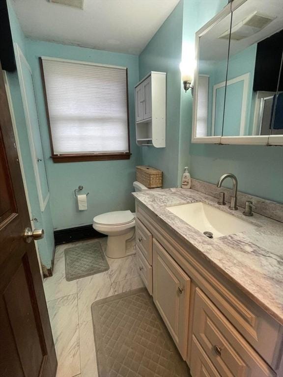 bathroom with toilet and vanity