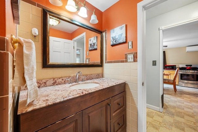 bathroom with tile walls and vanity