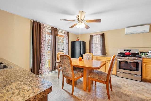 dining space featuring ceiling fan, plenty of natural light, and a wall mounted AC