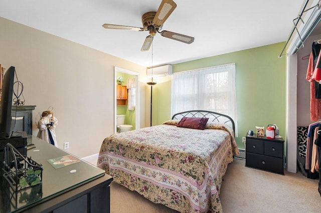 bedroom featuring light carpet, a ceiling fan, connected bathroom, a baseboard heating unit, and a wall mounted AC