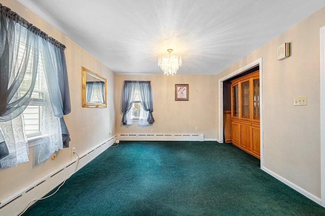 spare room with baseboards, baseboard heating, dark carpet, and a chandelier