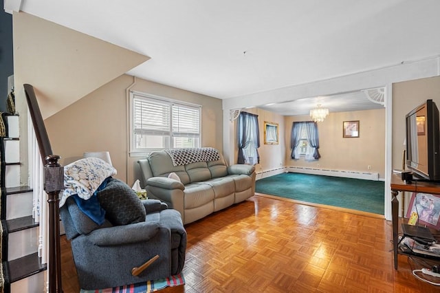 living room featuring a chandelier, a baseboard radiator, stairs, and baseboards