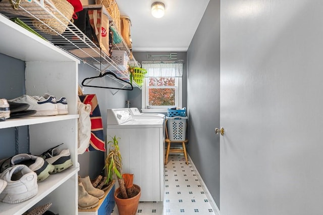 clothes washing area featuring laundry area, washing machine and clothes dryer, and tile patterned floors