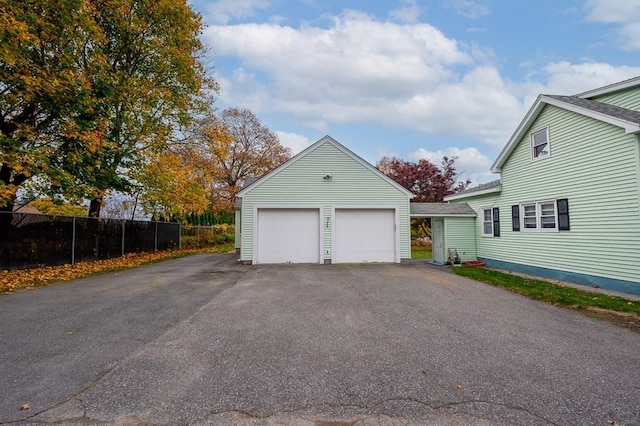 detached garage featuring fence