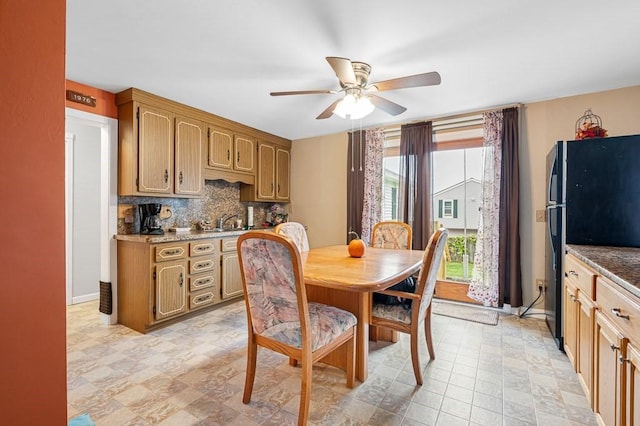 dining room featuring baseboards and a ceiling fan