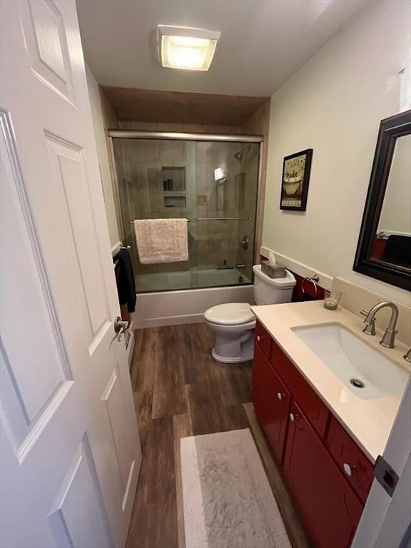 150 Sagamore St, Hamilton, MA 01982 - full bathroom with vanity, wood finished floors, and enclosed tub / shower combo