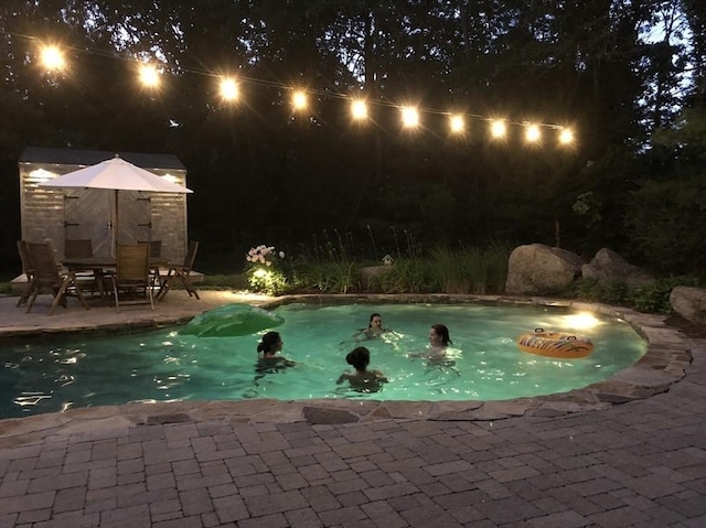 150 Sagamore St, Hamilton, MA 01982 - pool at night with a patio and outdoor dining area