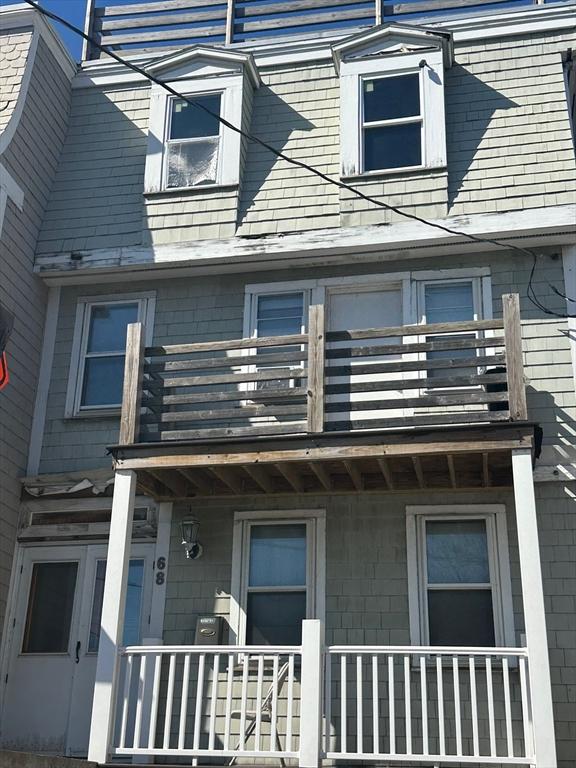 view of side of home with a porch