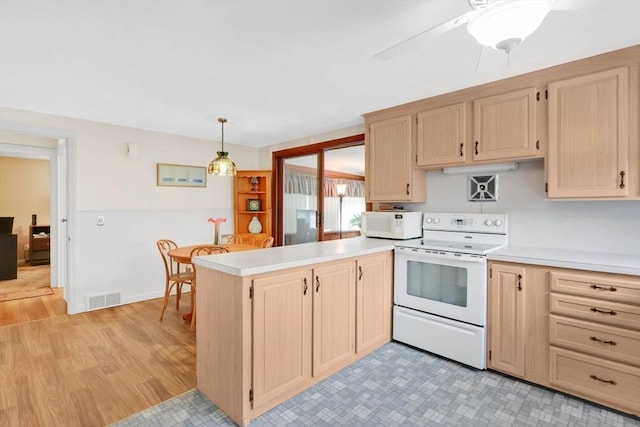 76 Regal St, Springfield, MA 01118 - kitchen with white appliances, light brown cabinets, and a peninsula