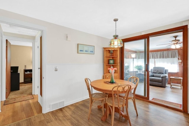 76 Regal St, Springfield, MA 01118 - dining area with light wood-style floors, wainscoting, and ceiling fan