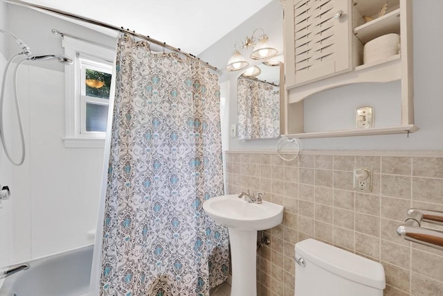 76 Regal St, Springfield, MA 01118 - bathroom with tile walls, toilet, shower / tub combo, wainscoting, and a sink