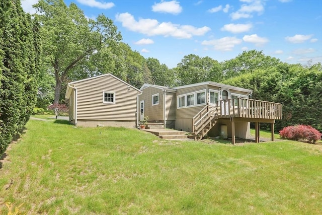 76 Regal St, Springfield, MA 01118 - back of property with a wooden deck, a yard, and stairway