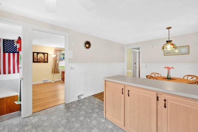 76 Regal St, Springfield, MA 01118 - kitchen featuring light brown cabinets, light countertops, pendant lighting, and wainscoting