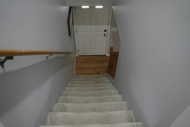 stairway featuring wood finished floors