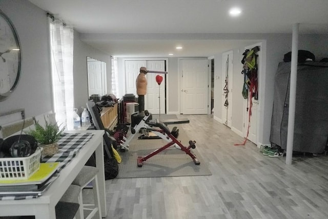 workout room with light wood-style floors, baseboards, and recessed lighting