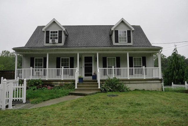 view of front of home featuring a porch, a front yard, fence, and a shingled roof