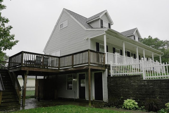 rear view of house with stairs, fence, and a wooden deck