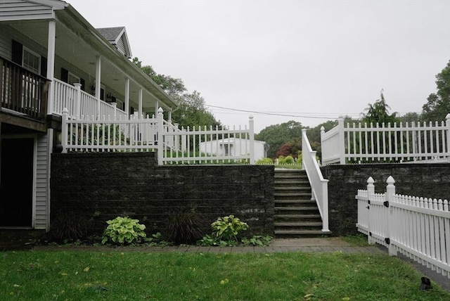 view of yard with fence and stairway