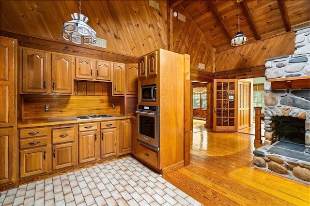 7 Hawthorne Dr, Southampton, MA 01073 - kitchen featuring appliances with stainless steel finishes, wooden walls, a wooden ceiling with exposed beams, light countertops, and brown cabinetry