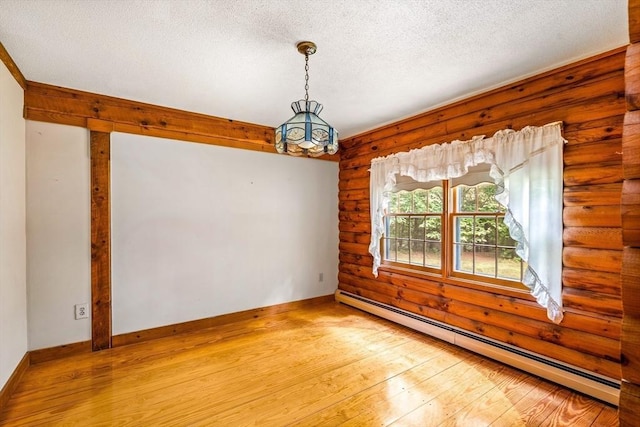 7 Hawthorne Dr, Southampton, MA 01073 - unfurnished room with a baseboard heating unit, light wood-style floors, log walls, a chandelier, and a textured ceiling